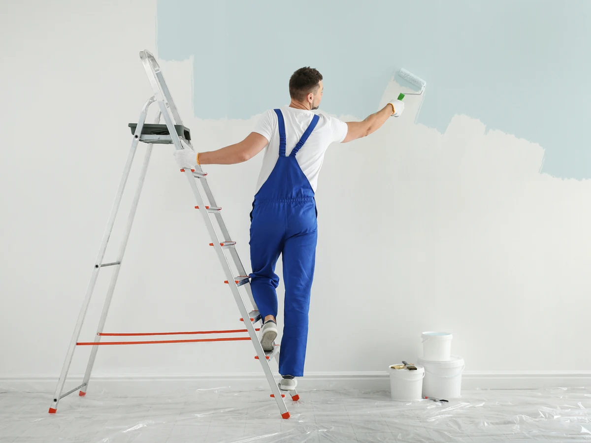 Painter and decorator in Shildon by Durham Painters, man in light blue painting interior