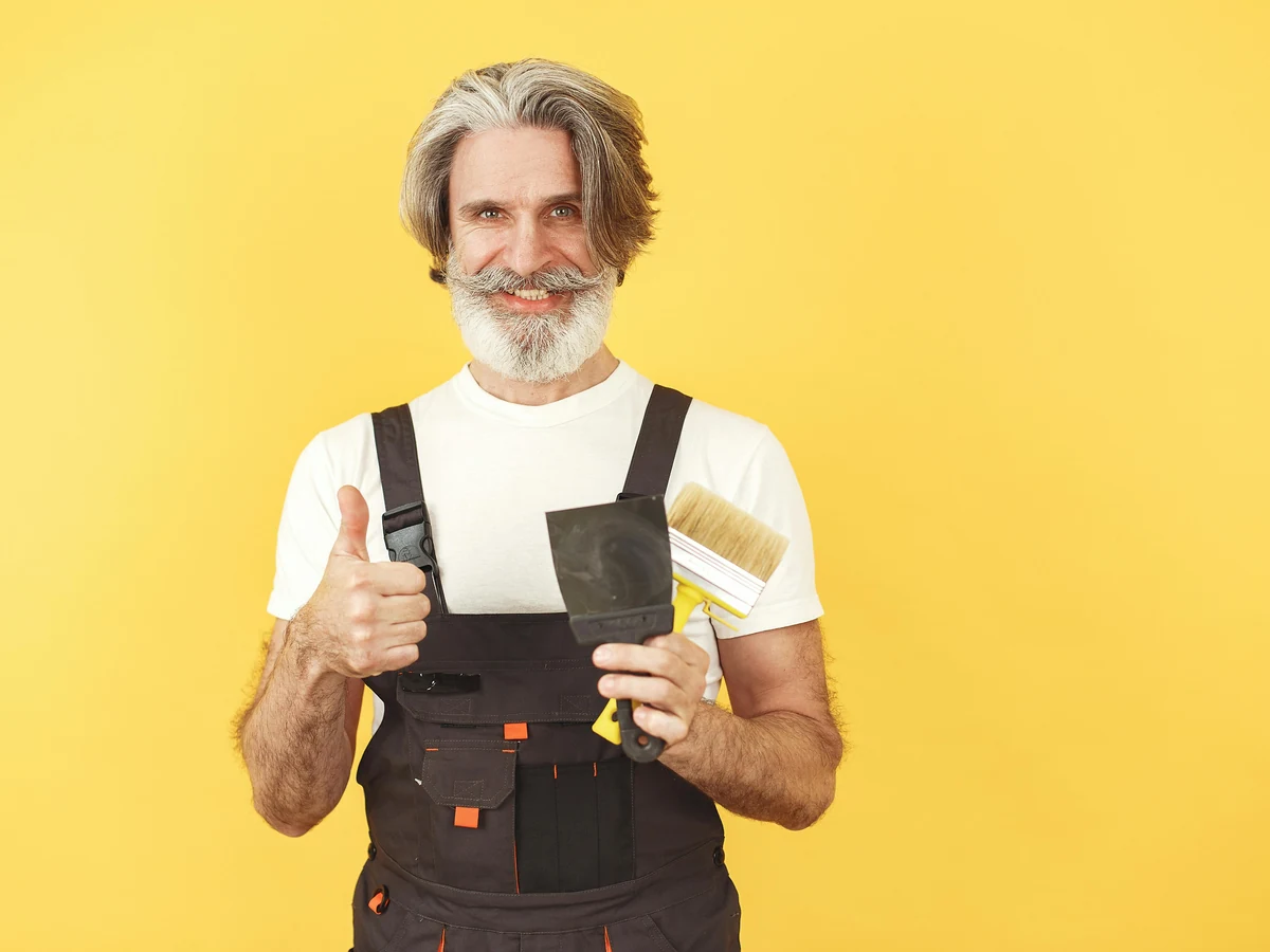 Painting Decorating Older Man Overalls in Durham